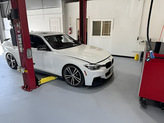 A white car is parked in a garage