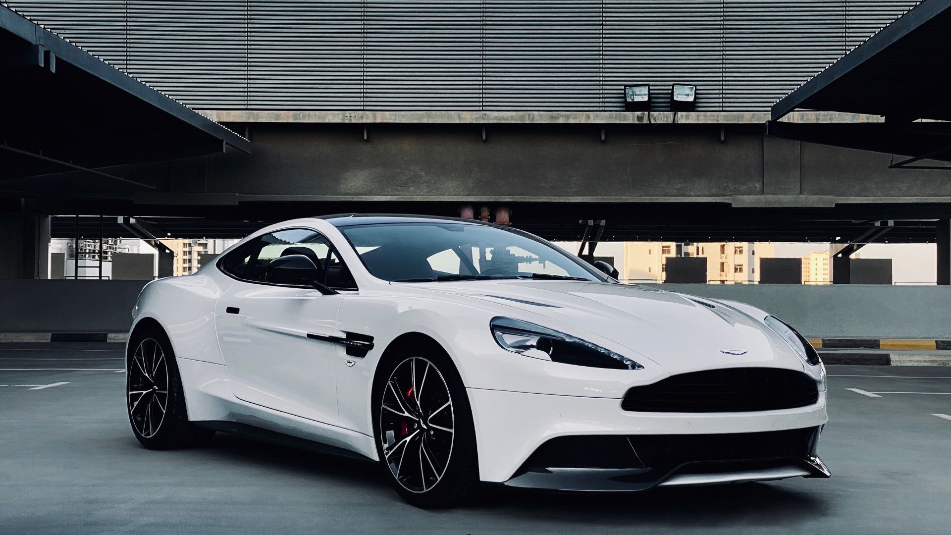 A white sports car parked in a parking lot