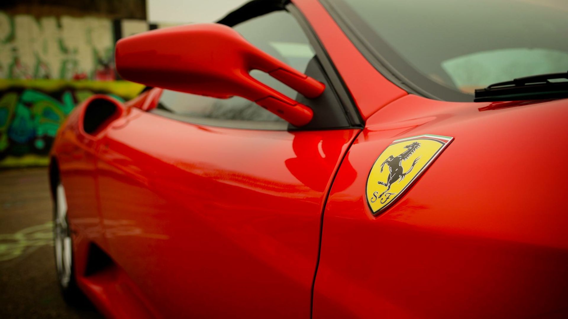 A red sports car parked in a parking lot