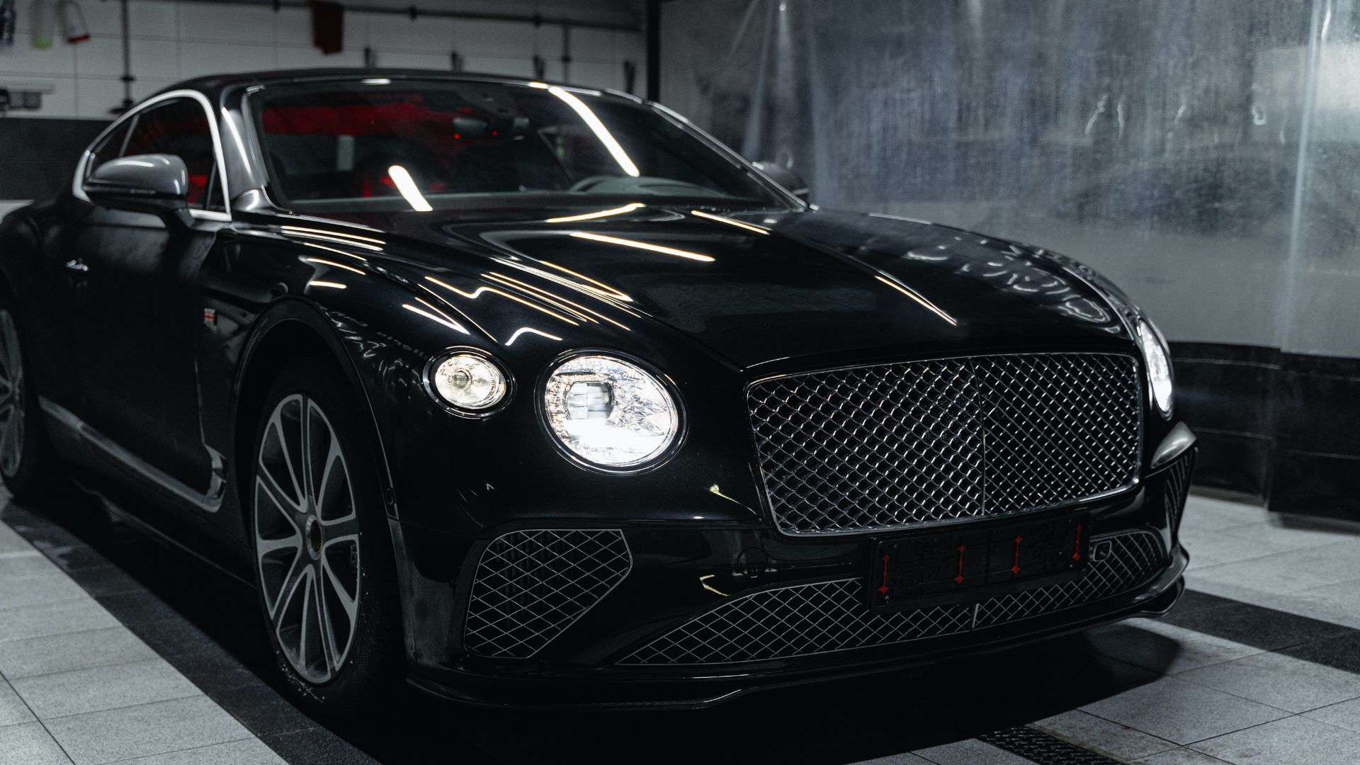 A black car is parked in a garage