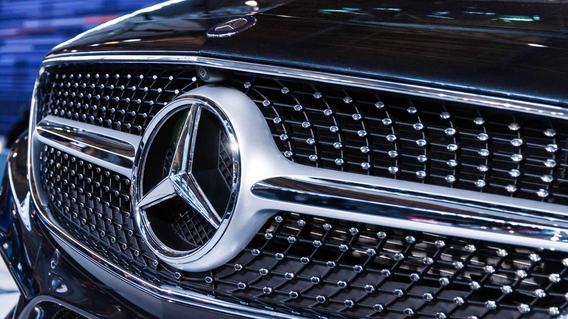 A close up of a mercedes logo on a car